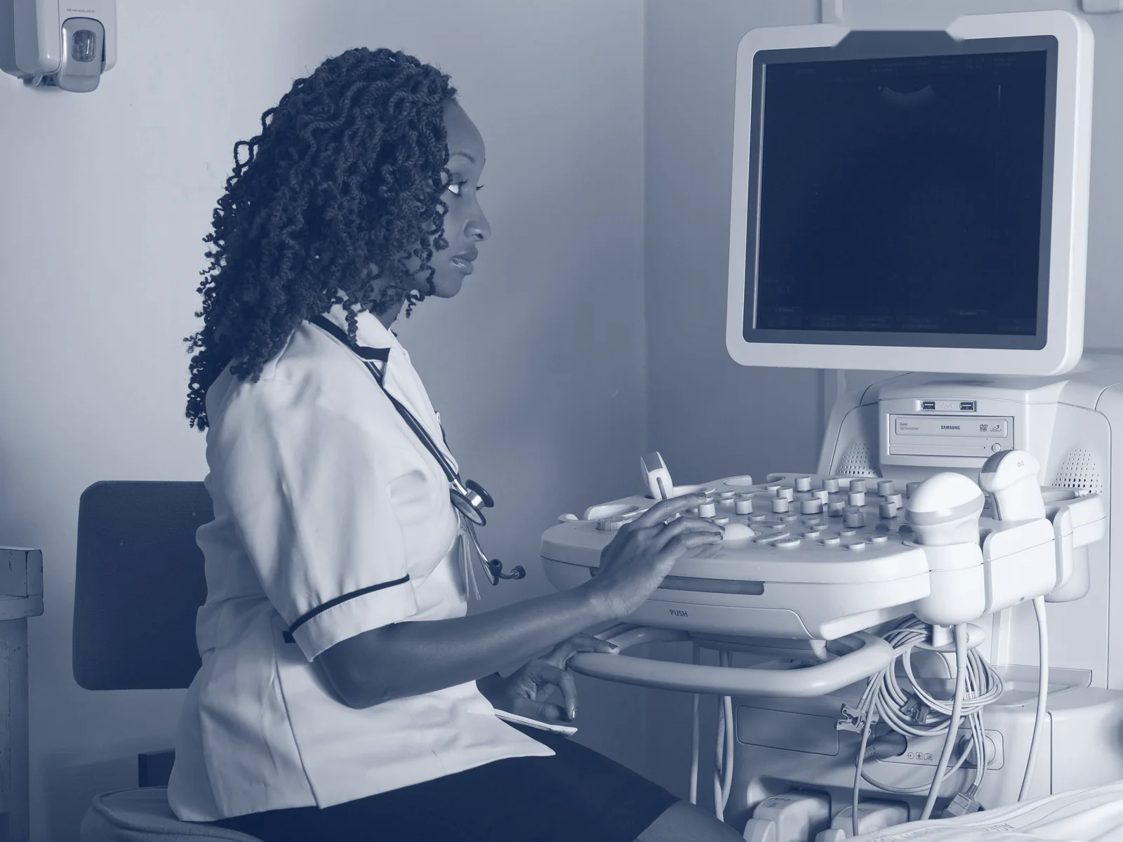A nurse in Kenya reviewing a patient's readings on screen